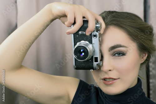 Girl with makeup and retro film camera