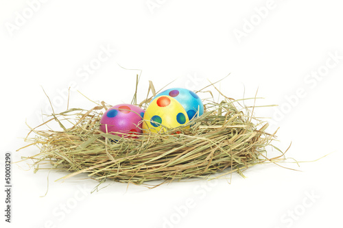 Three colorful Easter Eggs in a nest