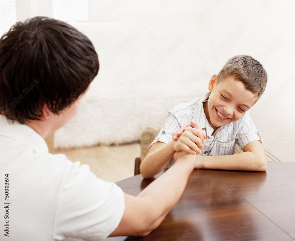 Father and son arm wrestling Father and son arm wrestling