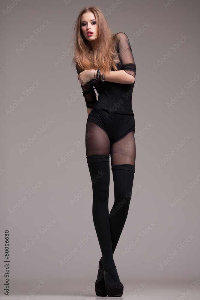 young model dressed in black posing fashion in the studio