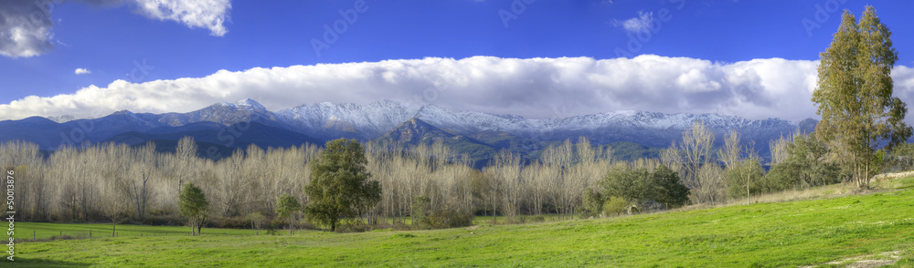 Snowy mountains and green valley in Gredos, Avila, Spain