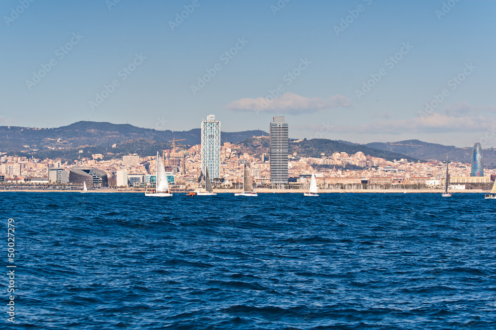 Sailing in Barcelona with the city in the background