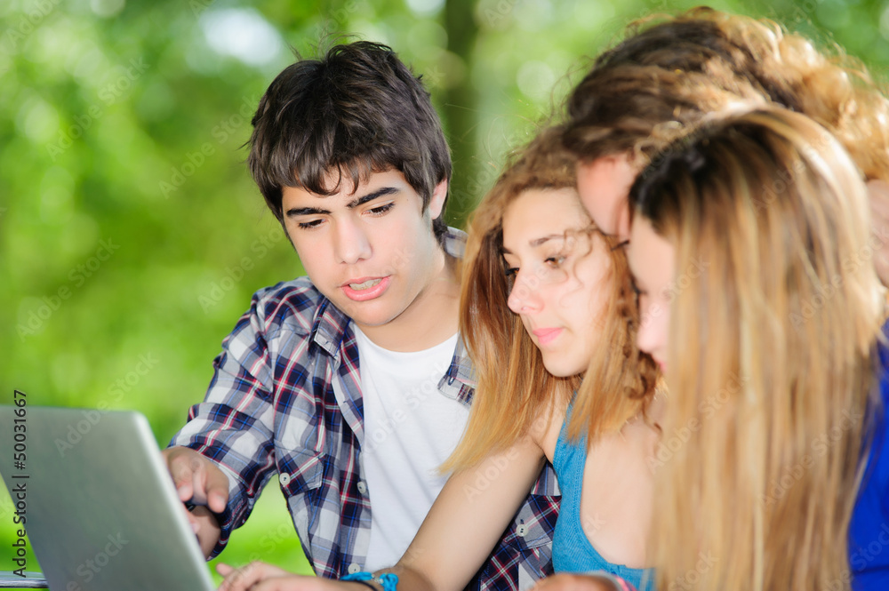 Group of young student using laptop outdoor,Italy Group of young student using laptop outdoor,Italy