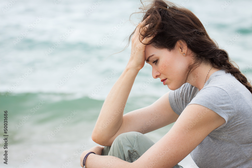 Sad and upset woman deep in thought - obrazy, fototapety, plakaty 