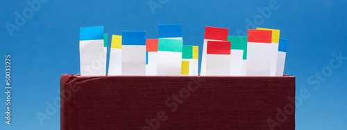 Book with bookmarks on blue background