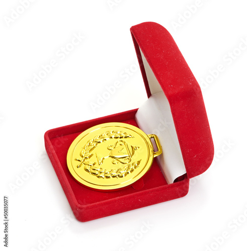 Golden medal in red gift box. photo