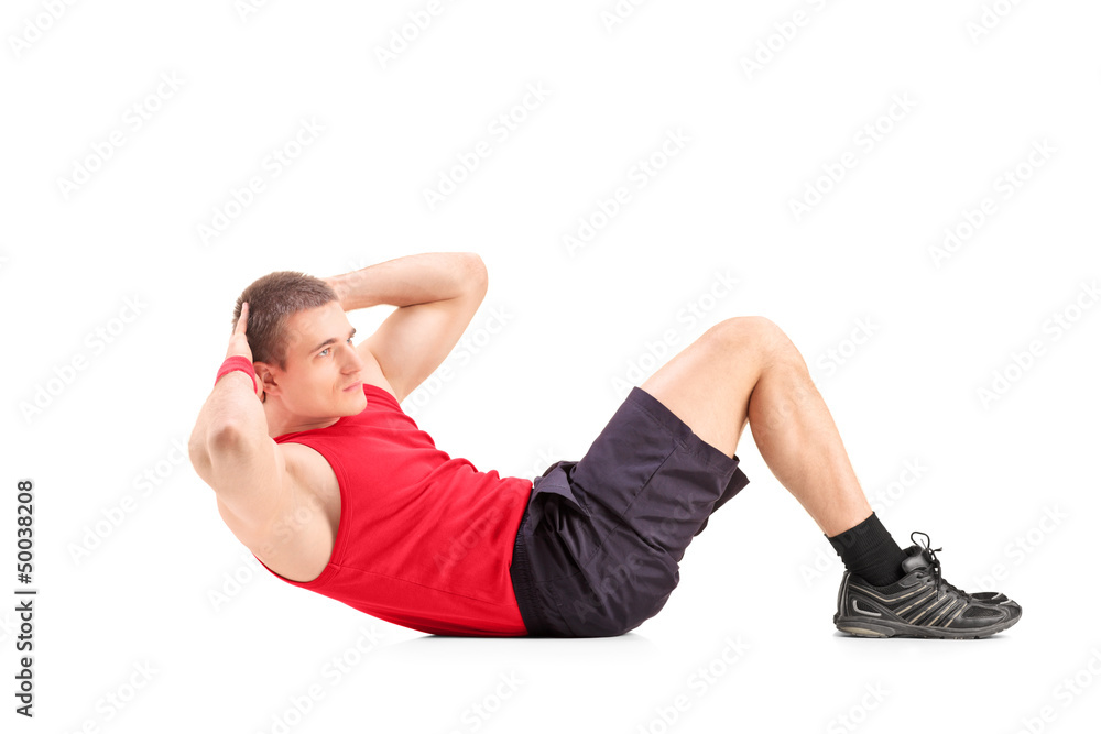 Fototapeta premium Young man doing abbs on the floor