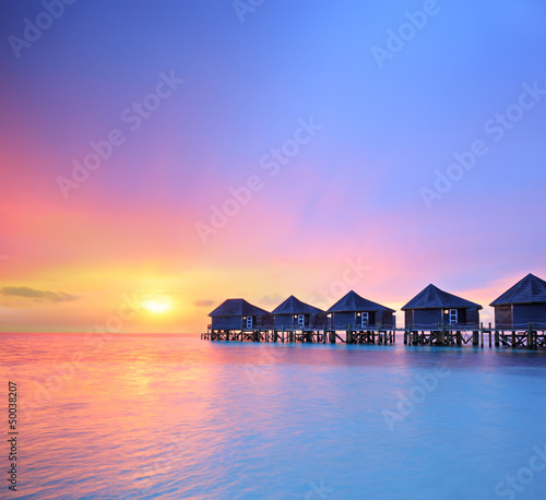 View of a beautiful sunset on a Malidves island and water villas