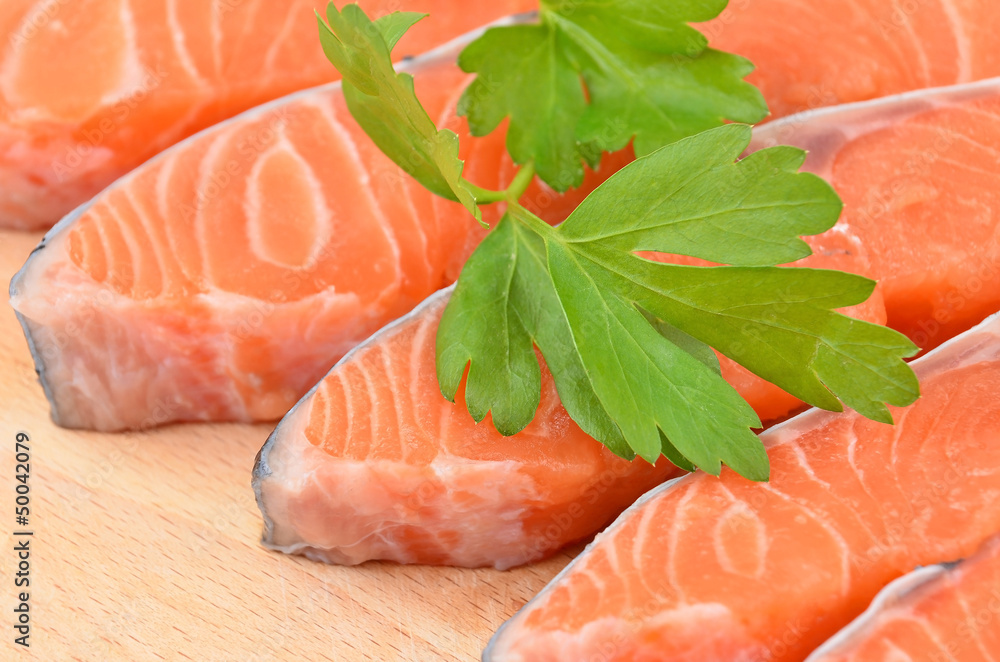 Fresh salmon steak slice on wooden background, DOF Fresh salmon steak slice on wooden background, DOF