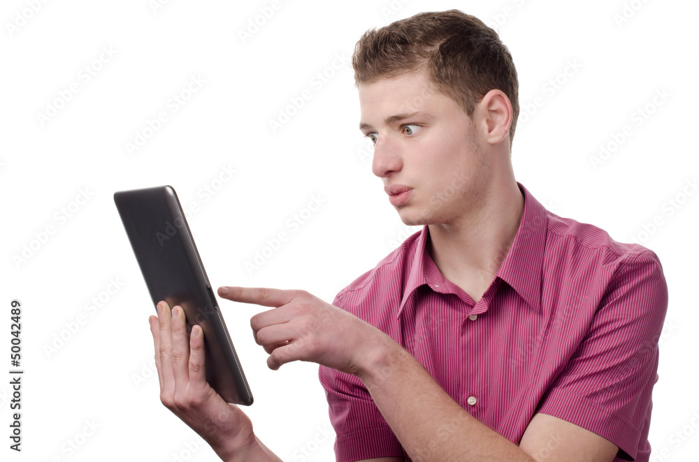 Man surprised looking and pointing to the tablet. Isolated.
