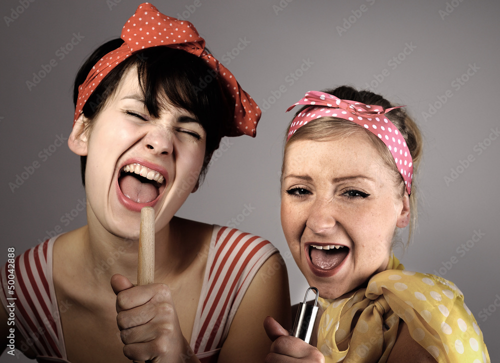 Two women singing together. Karaoke, retro style.