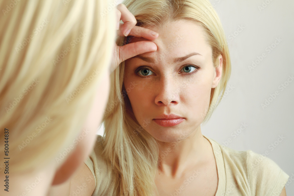 Fototapeta premium Woman caring of her beautiful skin on the face