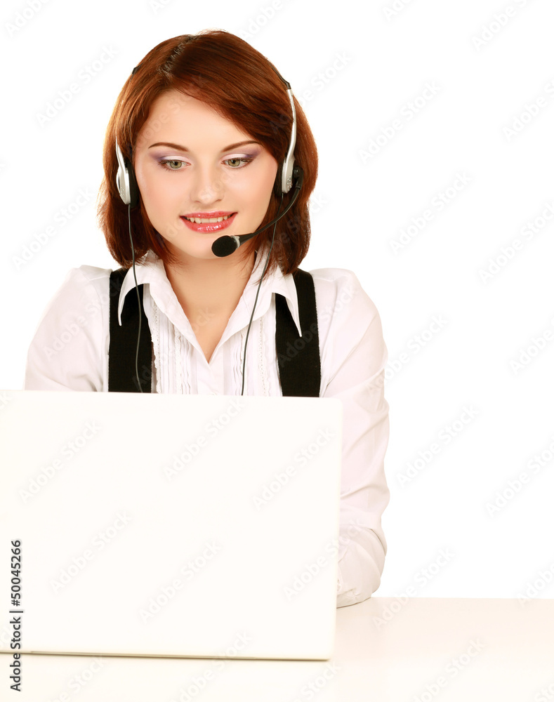 A young woman with a headset working on a laptop A young woman with a headset working on a laptop