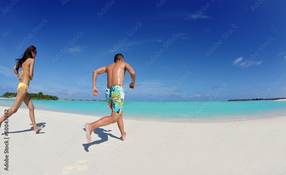 happy young  couple enjoying summer on beach