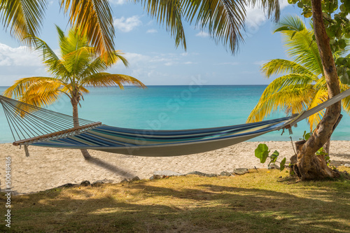 Fototapeta Naklejka Na Ścianę i Meble -  Fabric hammock by turquoise sea