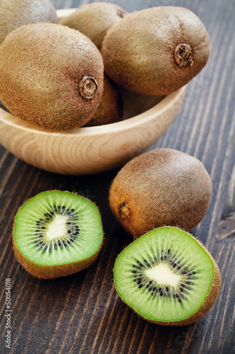 kiwi fruits on a brown wooden table.