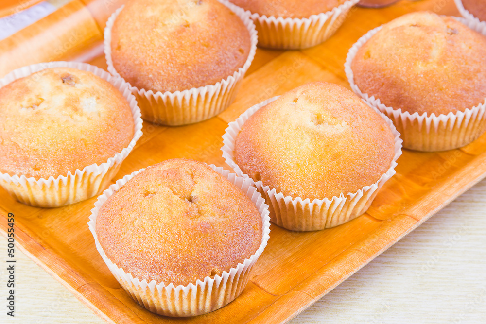 cakes in paper forms on a decorative tray cakes in paper forms on a decorative tray