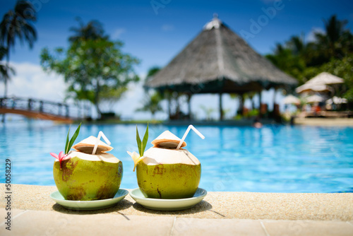 Fotografie, Obraz Pina colada drink in front of pool