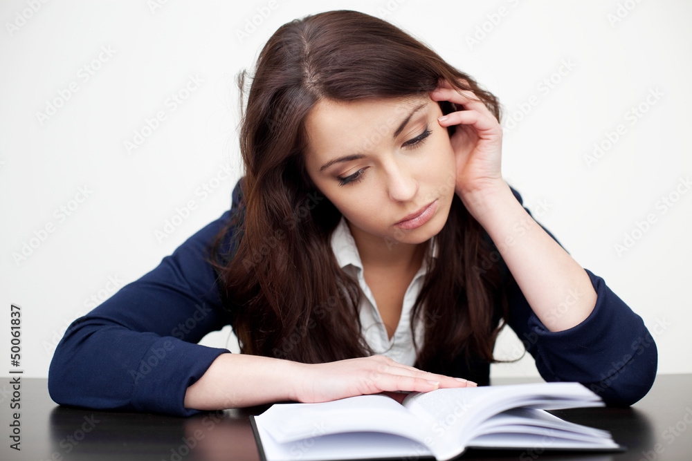 Tired student reading book Tired student reading book