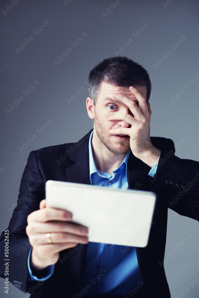 Shocked businessman with digital tablet Shocked businessman with digital tablet