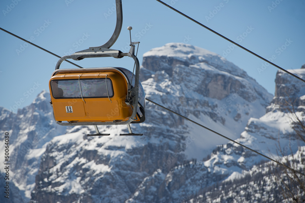 Obraz Chair Lift for skiers in Dolomites in winter time