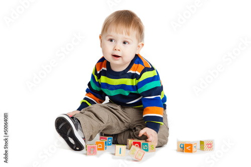 baby playing with wooden toy cubes with letters. Wooden alphabet