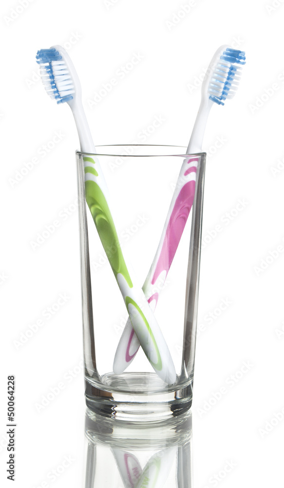 colorful toothbrushes in a glass over white colorful toothbrushes in a glass over white
