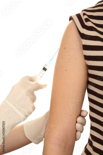 Doctor holding syringe with a vaccine in the patient shoulder 