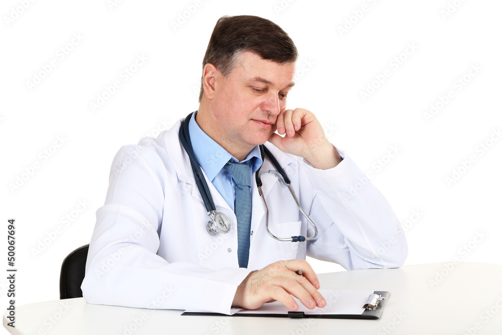 Medical doctor working at desk isolated on white Medical doctor working at desk isolated on white