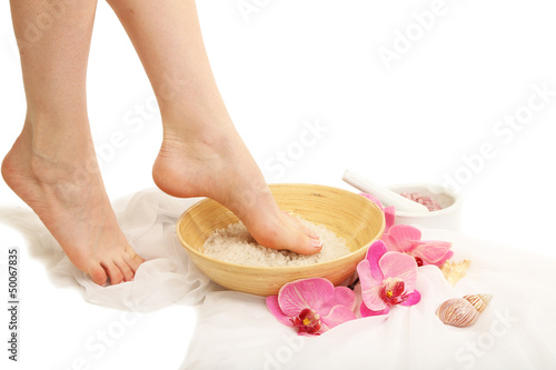 Fototapeta Naklejka Na Ścianę i Meble -  Female feet in spa bowl with sea salt, isolated on white