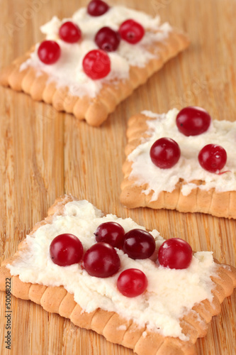 Cookie with cheese and cranberry, on wooden background