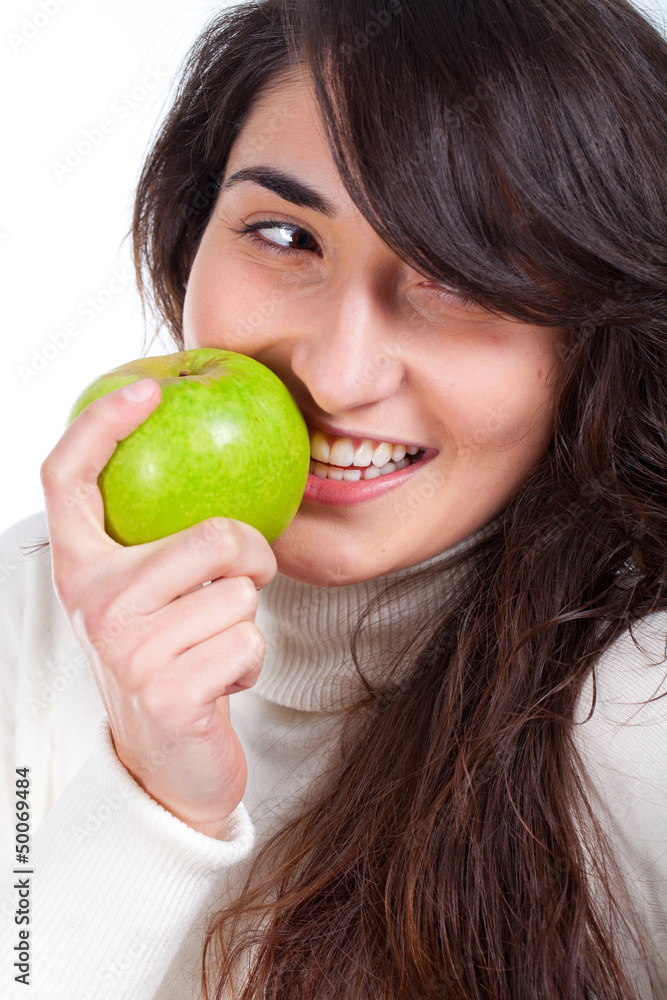 Young beautiful woman smiling with a green apple on hands Young beautiful woman smiling with a green apple on hands