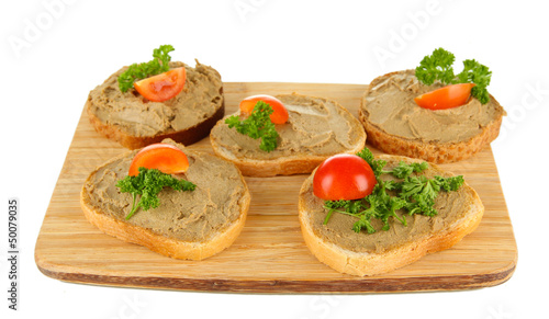 Fresh pate on bread on wooden board, isolated on white