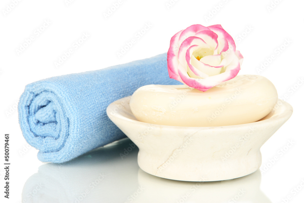 Rolled blue towel, soap bar and beautiful flower isolated Rolled blue towel, soap bar and beautiful flower isolated