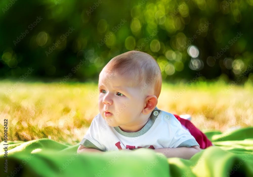 baby on the grass in the spring park baby on the grass in the spring park
