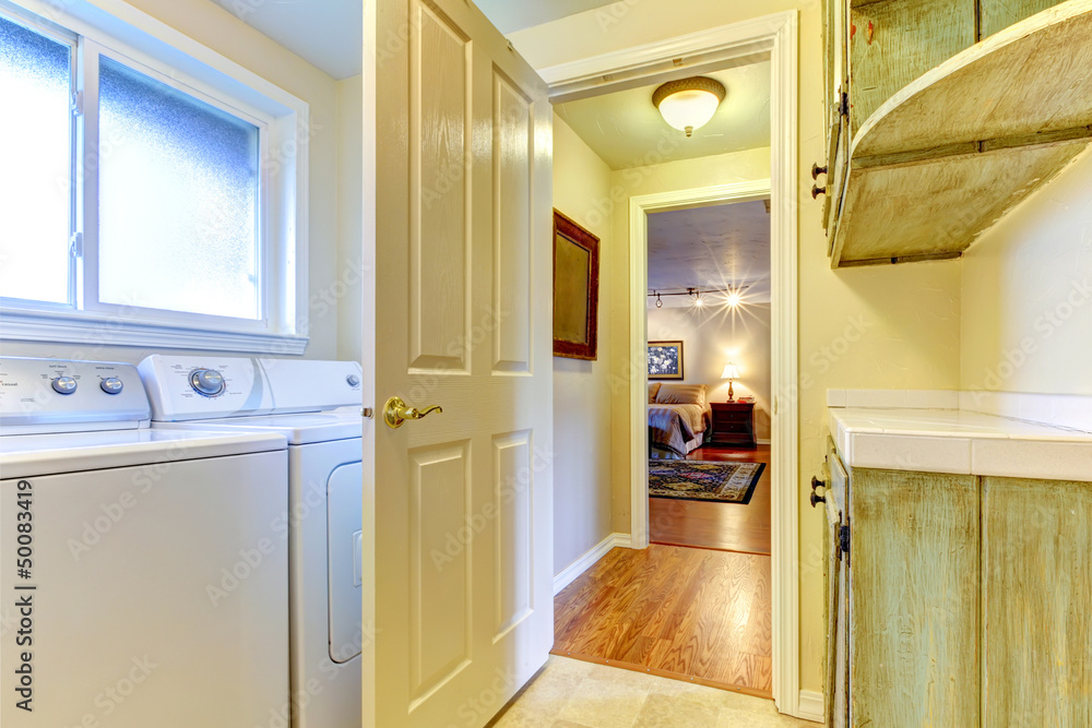Laundry room with open door to bedroom. Laundry room with open door to bedroom.
