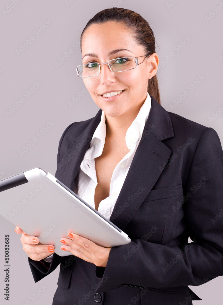Young smiling business woman with tablet computer on grey backgr Young smiling business woman with tablet computer on grey backgr