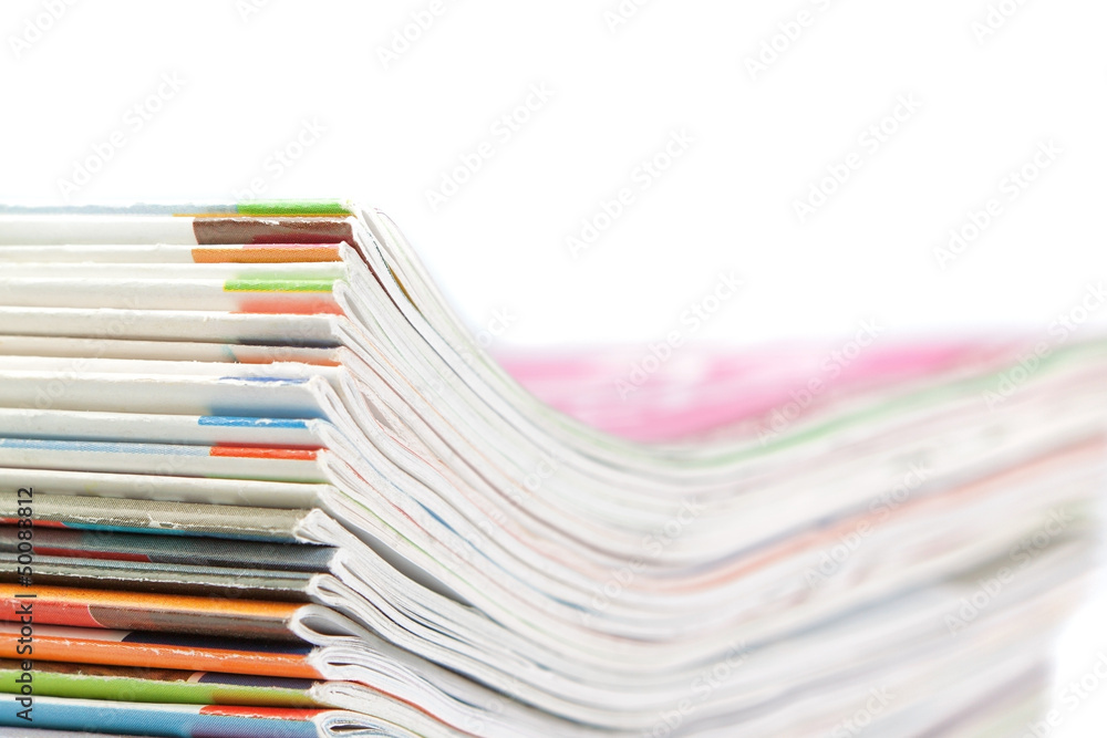 A stack of magazines on a white background. Close-up. A stack of magazines on a white background. Close-up.