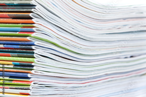 A large stack of colorful magazines. Close-up.