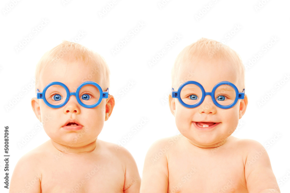 Two twins babies boys wearing glasses. StockFoto Adobe Stock