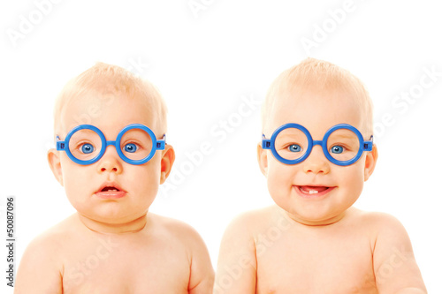 Two twins babies boys wearing glasses. photo