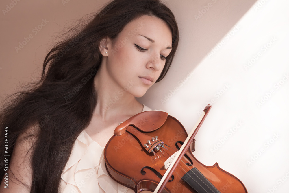 Pretty young female playing the violin, soft focus. Pretty young female playing the violin, soft focus.