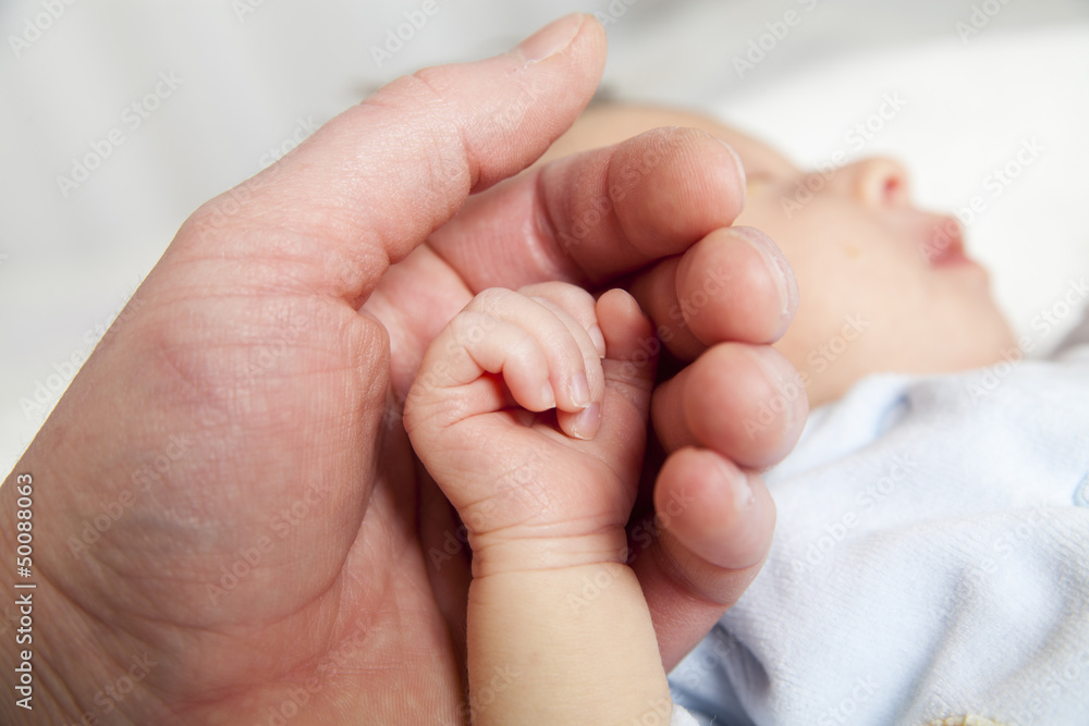 hold a hand of the newborn child hold a hand of the newborn child