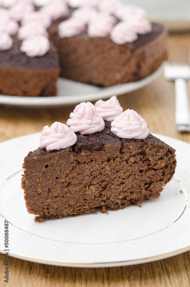 piece of chocolate cake with nuts on a plate vertical piece of chocolate cake with nuts on a plate vertical