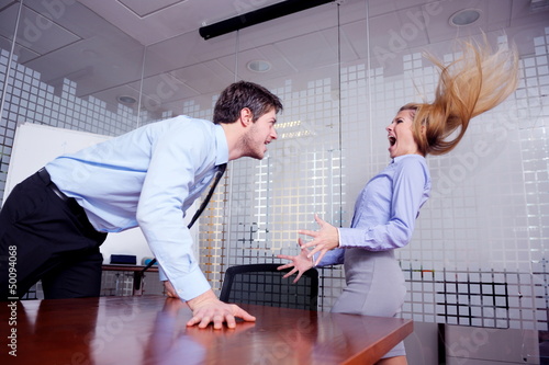 Angry busines sman screaming at employee photo