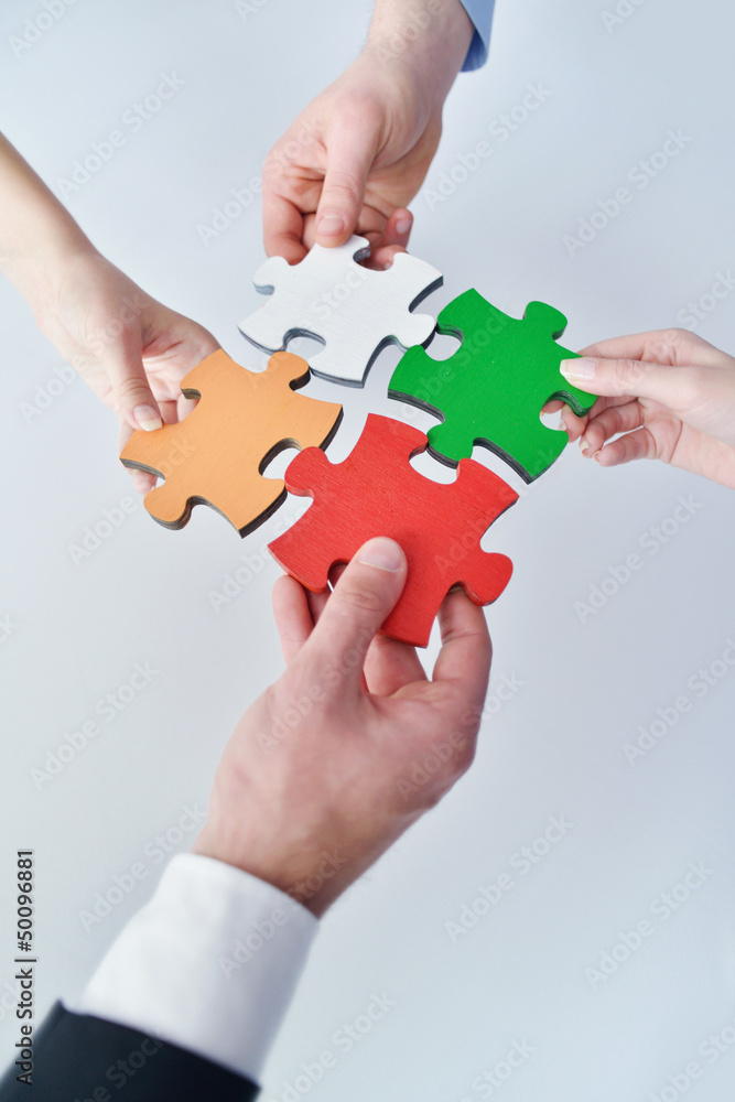 Group of business people assembling jigsaw puzzle Group of business people assembling jigsaw puzzle