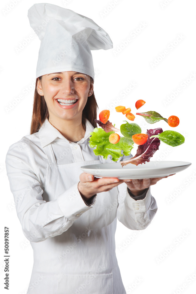 Happy cook woman holding a dish with floating vegetables Happy cook woman holding a dish with floating vegetables