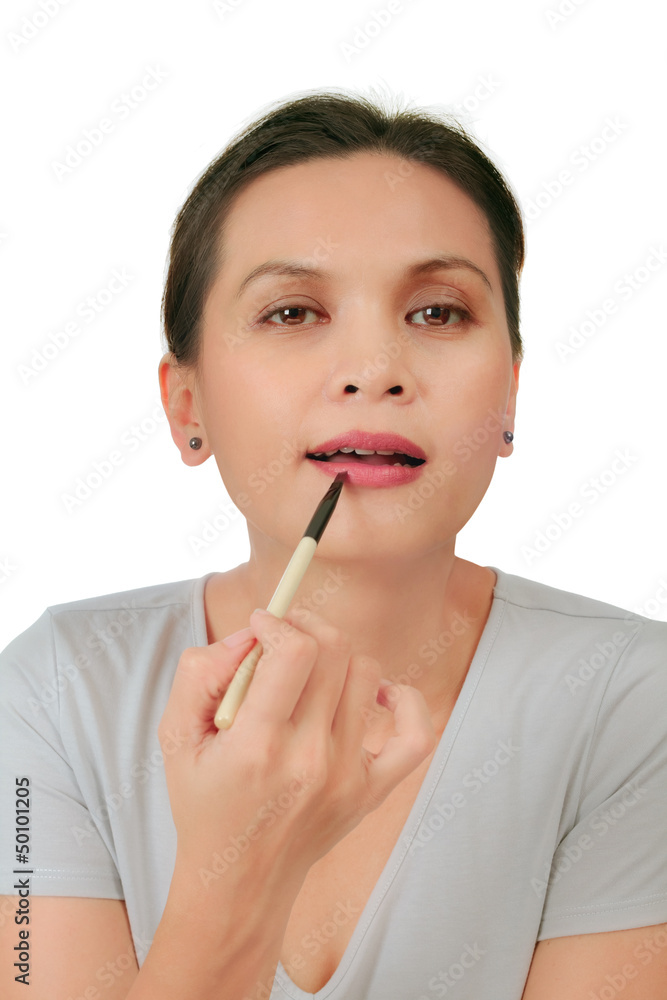 Isolated an asian middle age woman with make up on the lips Isolated an asian middle age woman with make up on the lips