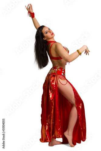 young girl in a red suit oriental dance in motion isolated on wh
