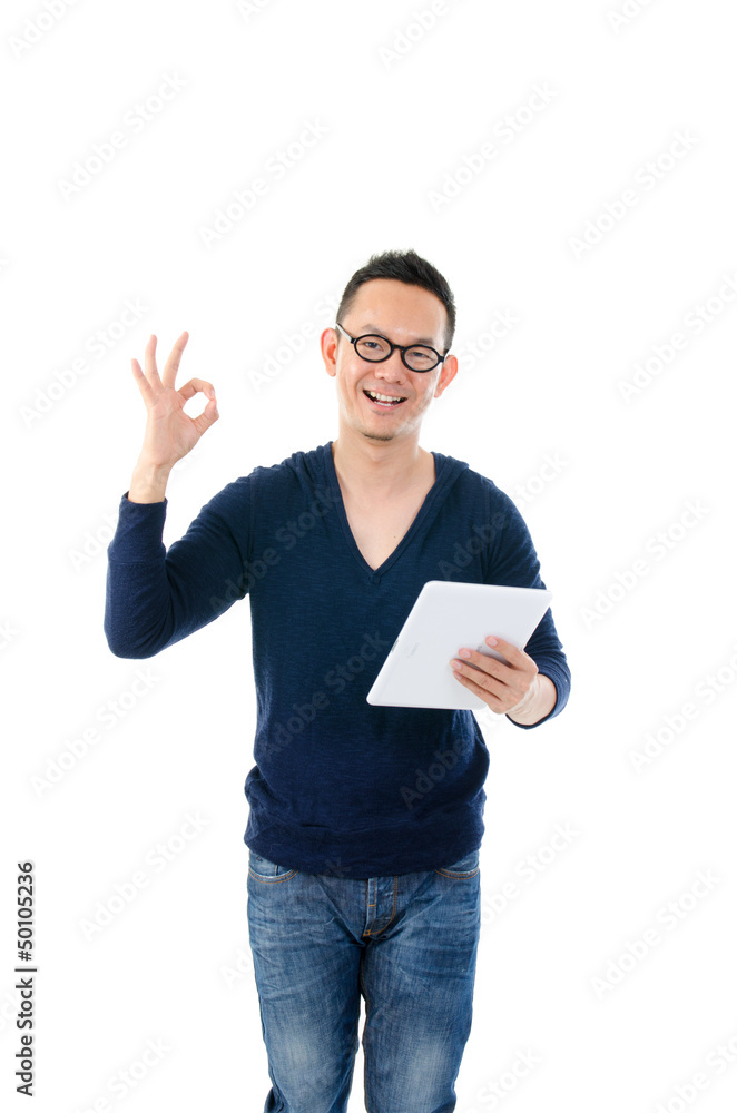 young asian male with a generic tablet. standing and isolated wi